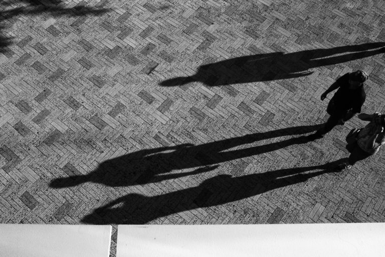 two people standing on concrete floor